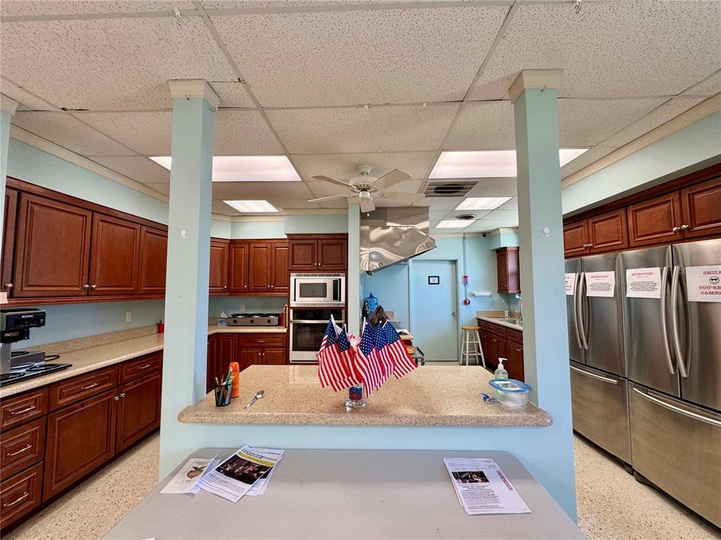 3301 Alt 19, Unit 404 Dunedin, FL 34698 - Photo 59 of 67 a kitchen with stainless steel appliances kitchen island granite countertop a sink and cabinets