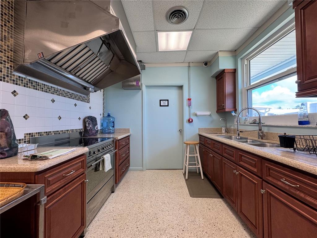 3301 Alt 19, Unit 404 Dunedin, FL 34698 - Photo 60 of 67 a kitchen with stainless steel appliances granite countertop a stove a sink dishwasher and a refrigerator