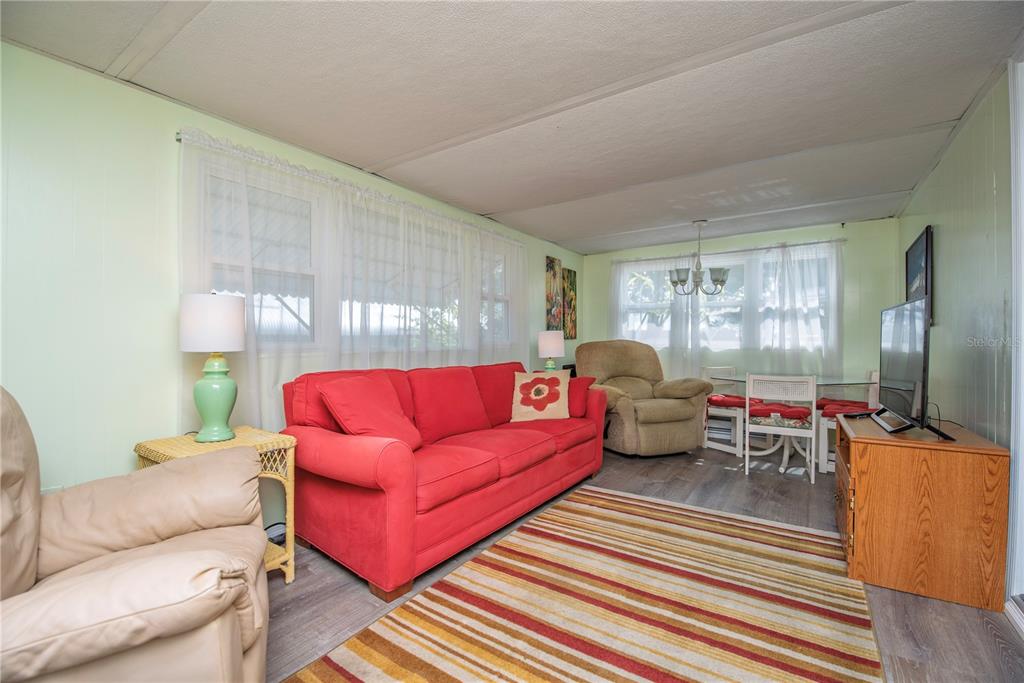 3301 Alt 19, Unit 404 Dunedin, FL 34698 - Photo 6 of 67 a living room with furniture and a large window