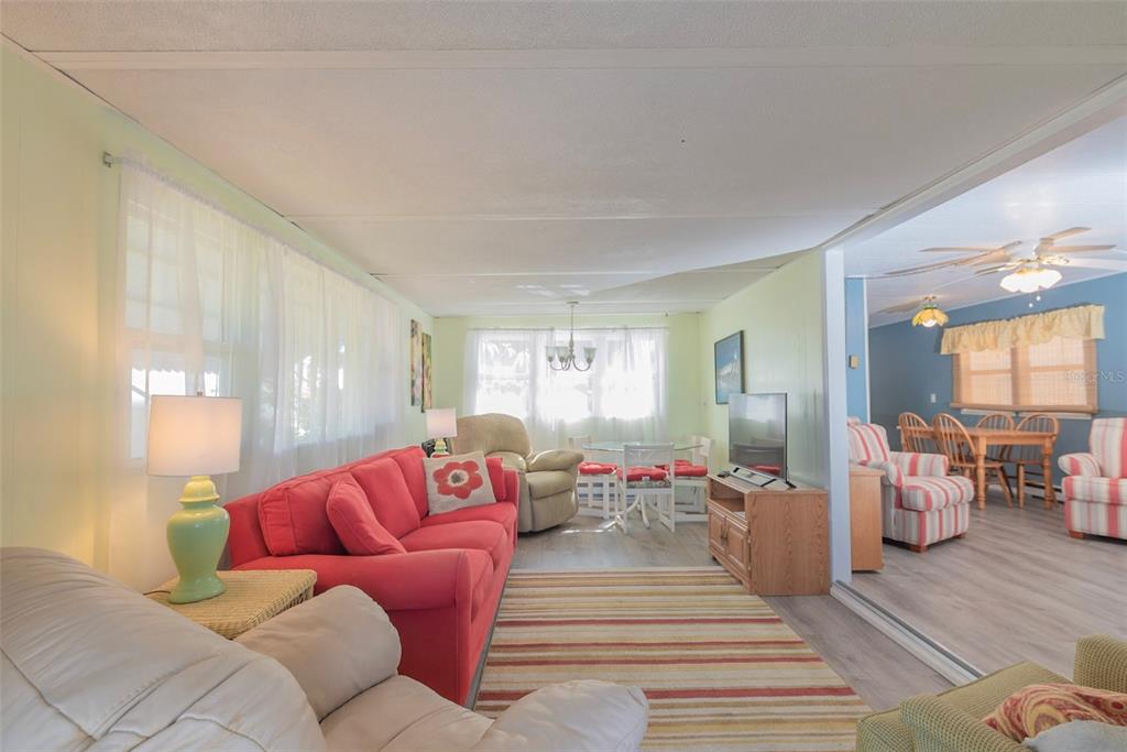 3301 Alt 19, Unit 404 Dunedin, FL 34698 - Photo 7 of 67 a living room with furniture and wooden floor
