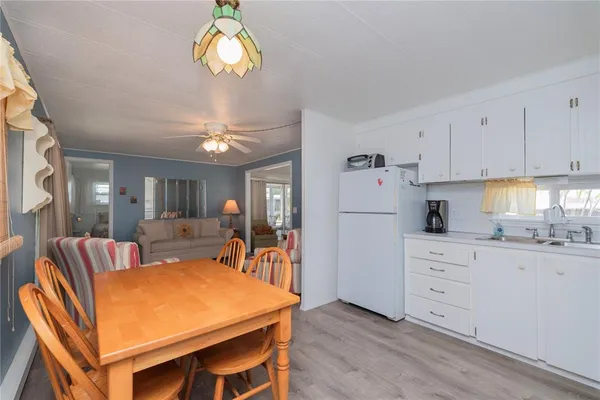 a view of a livingroom with furniture and chandelier fan