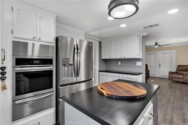 a kitchen with kitchen island a stove and a refrigerator