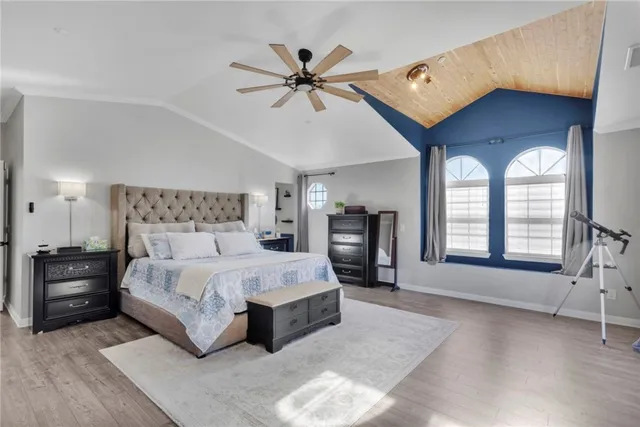 a spacious bedroom with a bed and window