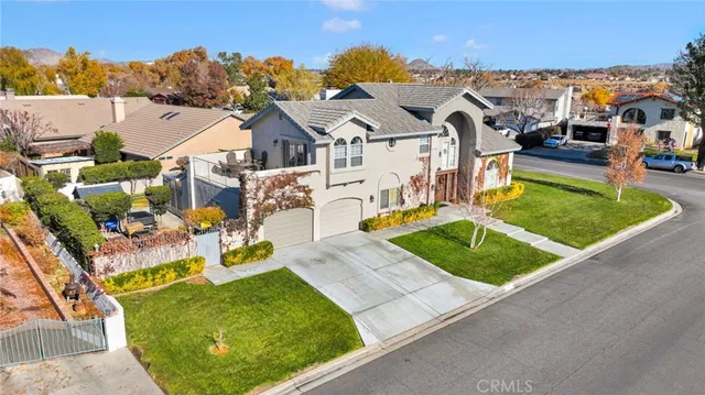 an aerial view of a house with a garden and houses