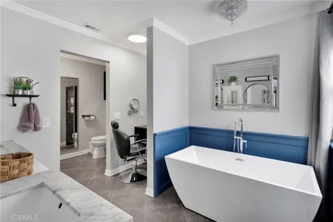 a white bath tub sitting next to a bathroom