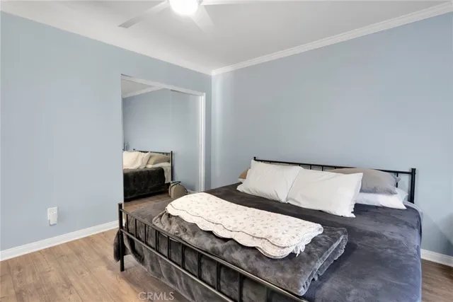 a bedroom with a bed and wooden floor