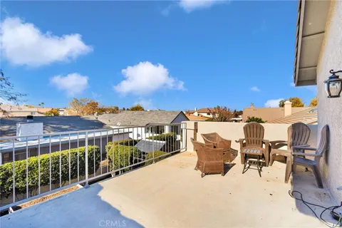 a view of a patio with a table and chairs