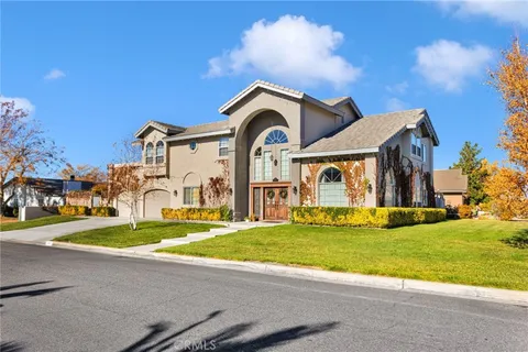a front view of a house with a garden and yard