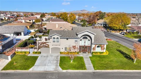 an aerial view of a house with garden space ocean view