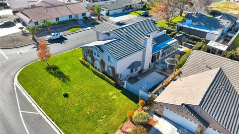 an aerial view of a pool patio kitchen and outdoor seating
