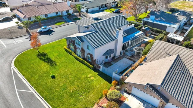 an aerial view of a pool patio kitchen and outdoor seating