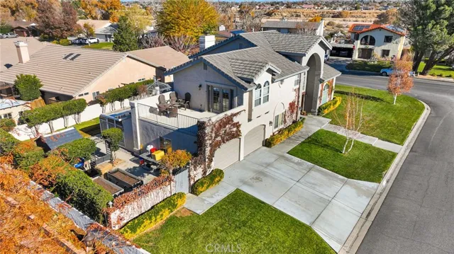 an aerial view of a house with a garden and lake view