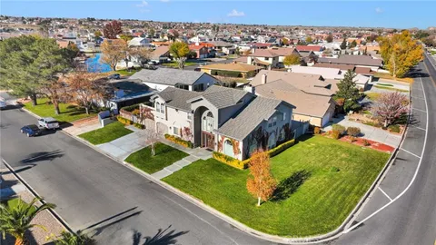 an aerial view of a house with a garden and swimming pool