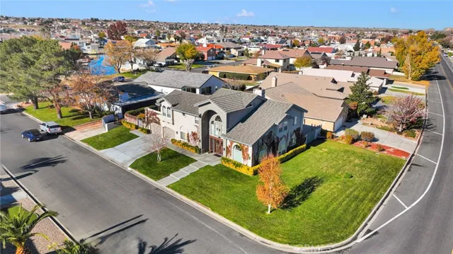an aerial view of a house with a garden and swimming pool