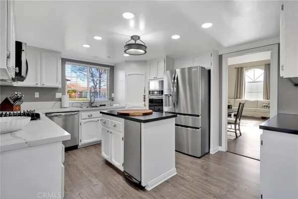 a kitchen with stainless steel appliances a refrigerator sink and stove