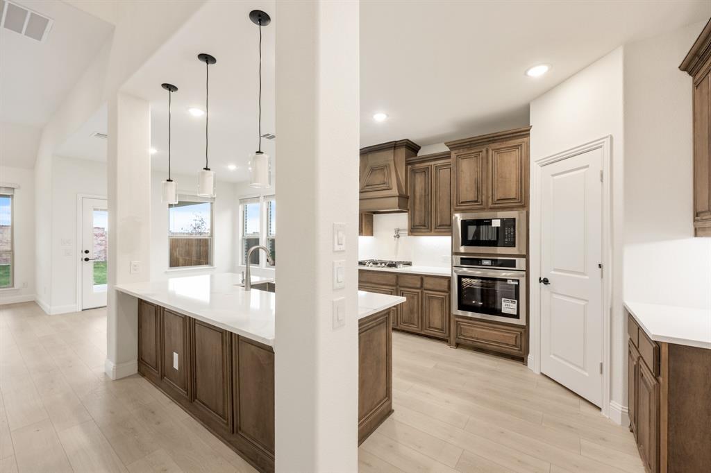 2813 Spg Vly Way Anna, TX 75409 - Photo 11 of 40 a large white kitchen with stainless steel appliances