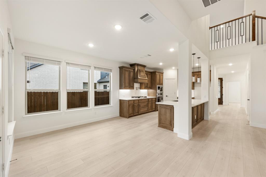 2813 Spg Vly Way Anna, TX 75409 - Photo 13 of 40 a view of a big room with a large window and kitchen view