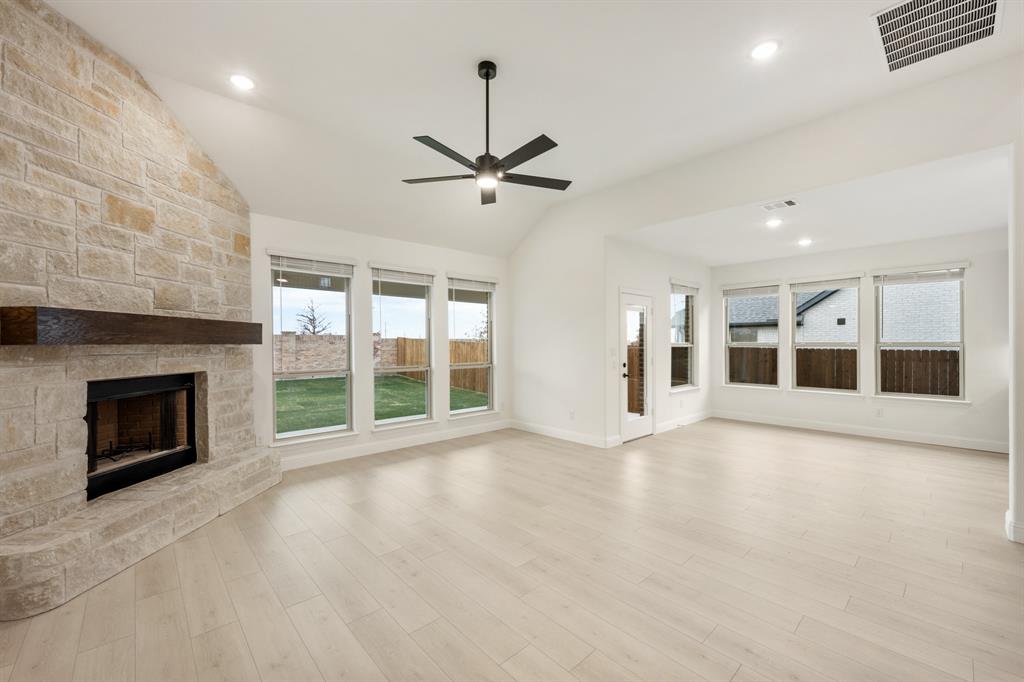 2813 Spg Vly Way Anna, TX 75409 - Photo 19 of 40 a view of an empty room with a fireplace and a window