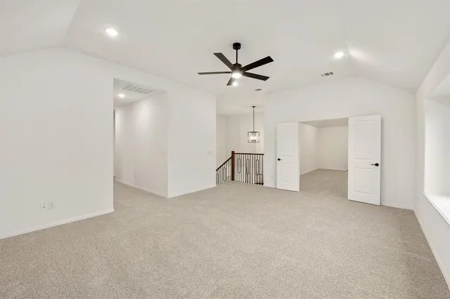 an empty room with a ceiling fan and a window