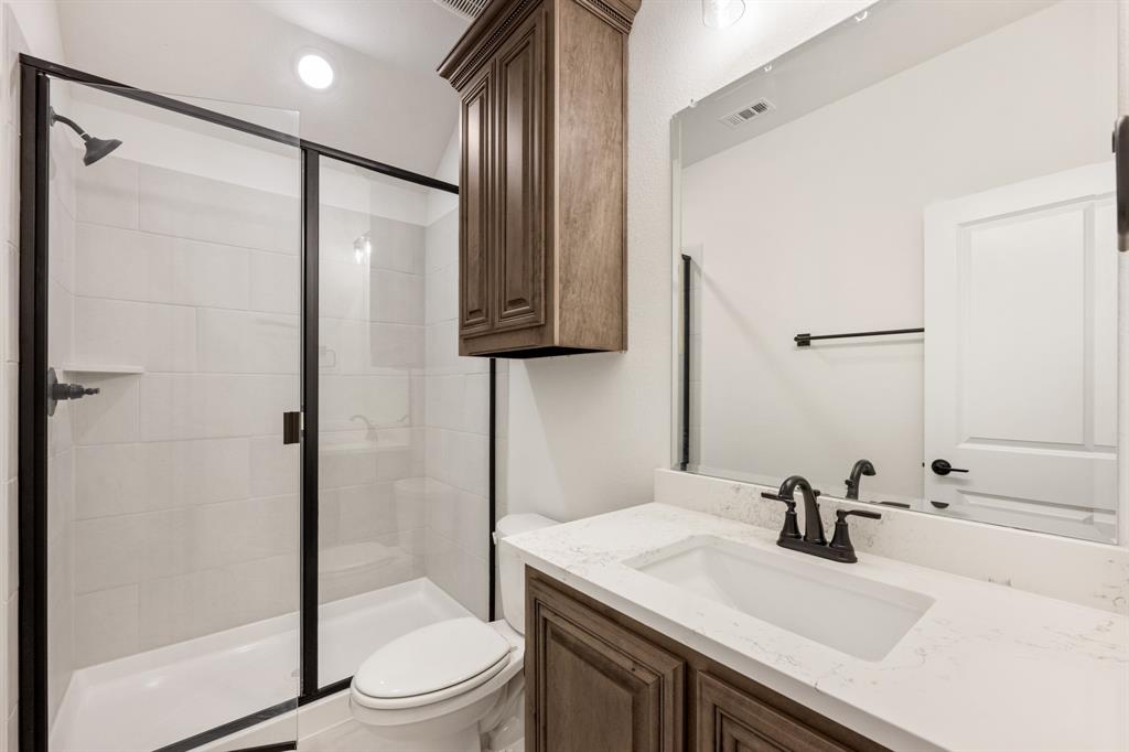 2813 Spg Vly Way Anna, TX 75409 - Photo 36 of 40 a bathroom with a sink toilet a mirror and shower