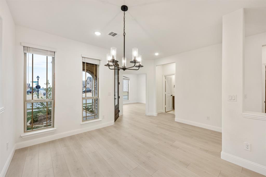 2813 Spg Vly Way Anna, TX 75409 - Photo 6 of 40 a view of an empty room with window and cabinet