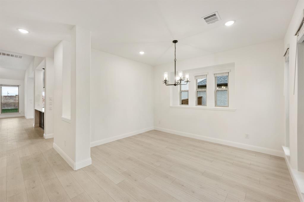 2813 Spg Vly Way Anna, TX 75409 - Photo 8 of 40 wooden floor in an empty room with a window