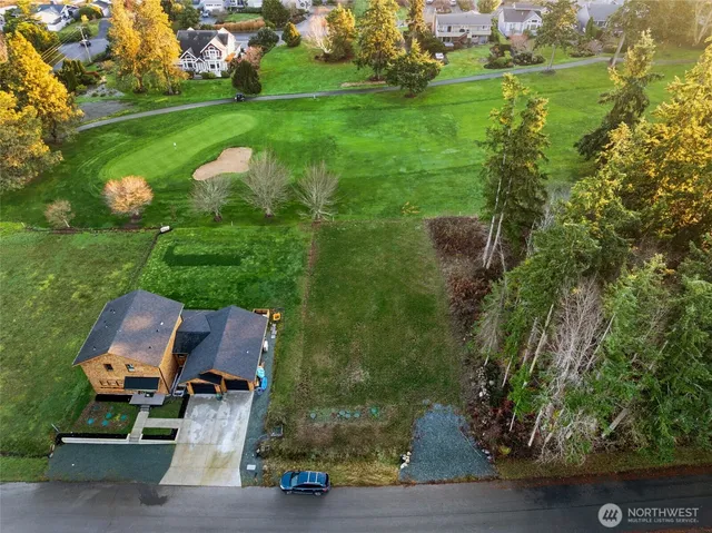 an aerial view of a house with garden space and street view