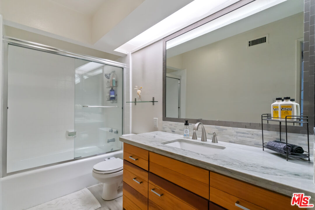 6209 Pacific Avenue, Unit 103 Playa del Rey, CA 90293 - Photo 15 of 40 a bathroom with a granite countertop sink a toilet and shower