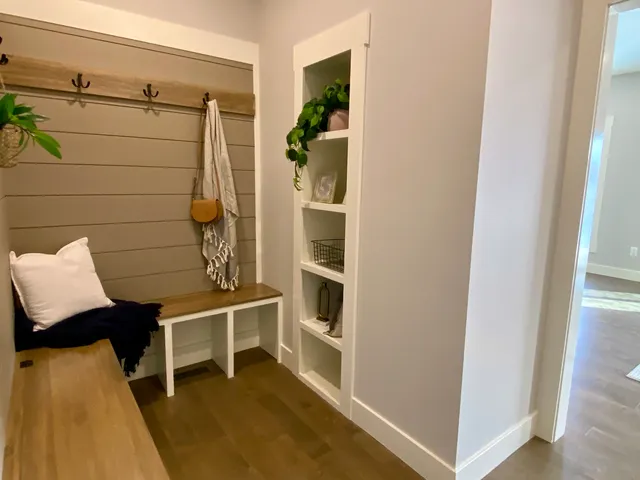 a view of furniture and bedroom with wooden floor and windows