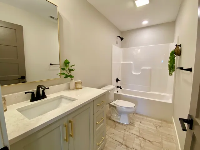 a bedroom with bed and ceiling fan