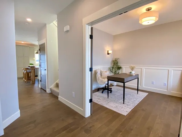 a view of a livingroom with furniture and a dining table