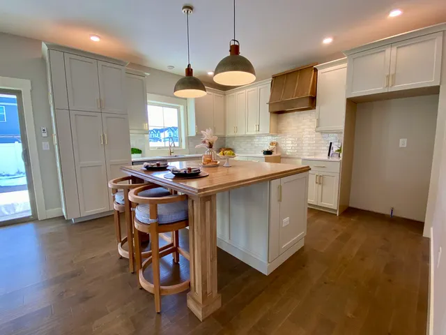 a kitchen with stainless steel appliances granite countertop a sink a stove and a refrigerator