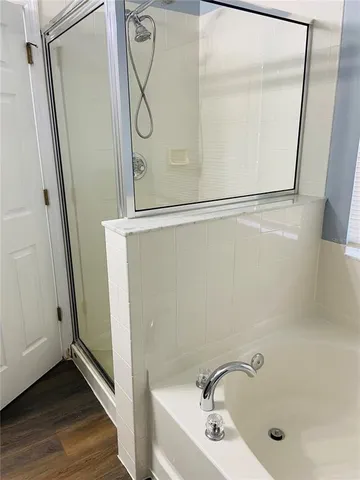 a bathroom with a tub and shower