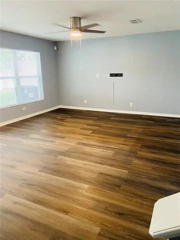 a view of a room with wooden floor