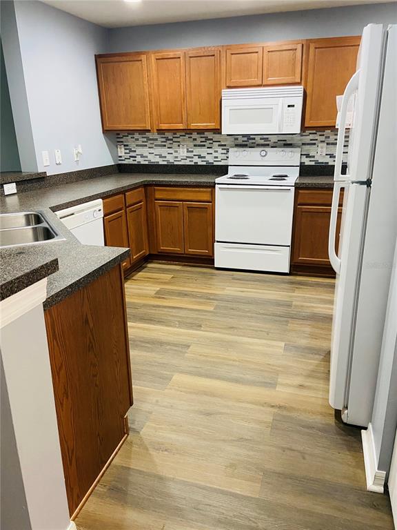 11658 Mango Ridge Boulevard Seffner, FL 33584 - Photo 7 of 20 a kitchen with granite countertop wooden cabinets and a stove