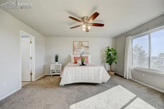 a bedroom with a bed lamp and window