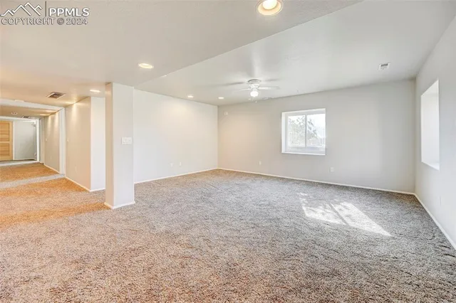 a view of an empty room and a window