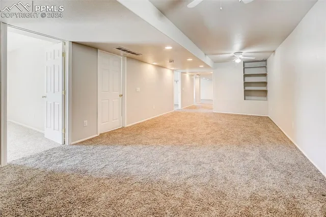 a view of an empty room and a window