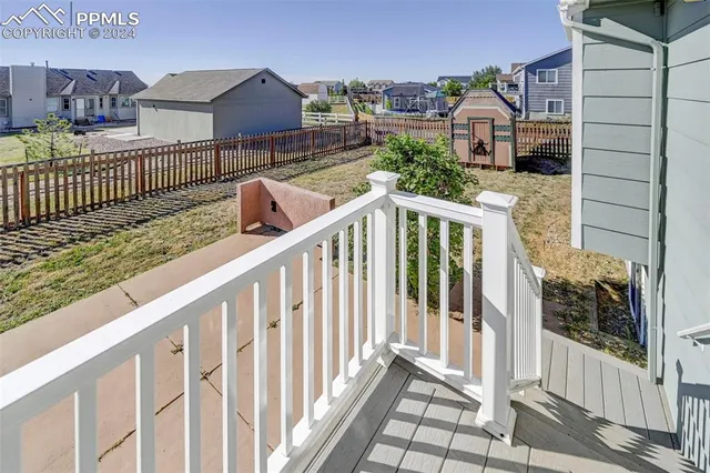 a view of a balcony with wooden fence