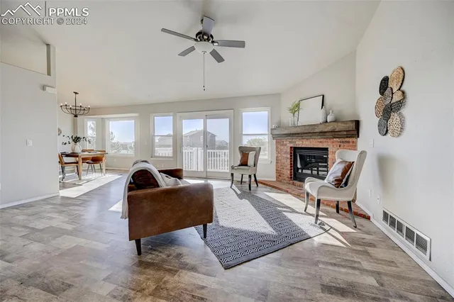 a living room with furniture fireplace and window
