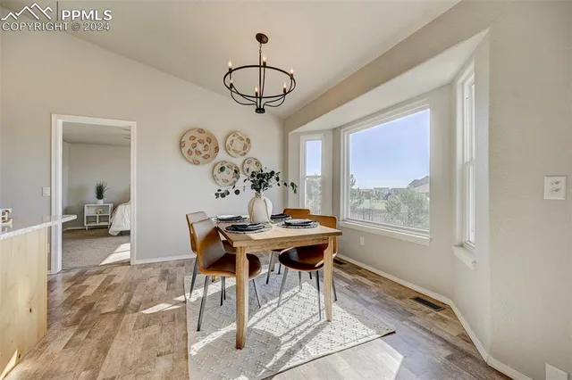 a view of a dining room with furniture window and wooden floor