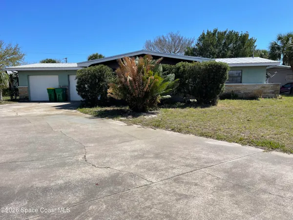 a backyard of a house with plants and trees