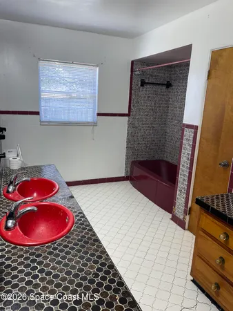 a bathroom with a sink a stove and a shower