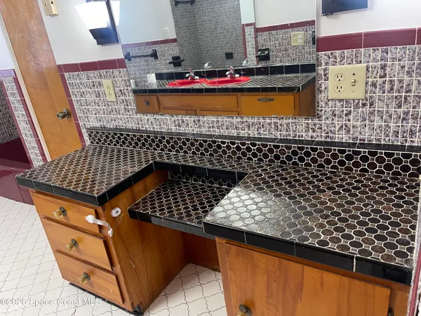 a bedroom with a bed and a mirror