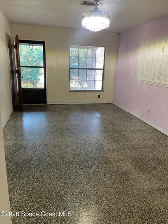 an empty room with a empty space and windows