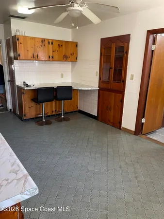 a view of a room with closet and chandelier fan