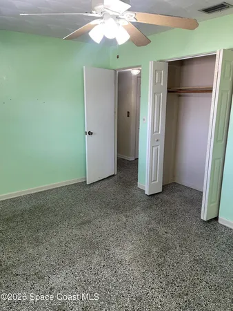 an empty room with closet and mirror