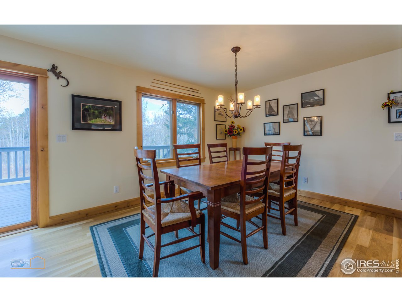 3301 Ridge Road Nederland, CO 80466 - Photo 11 of 40 a dining room with furniture a chandelier and wooden floor
