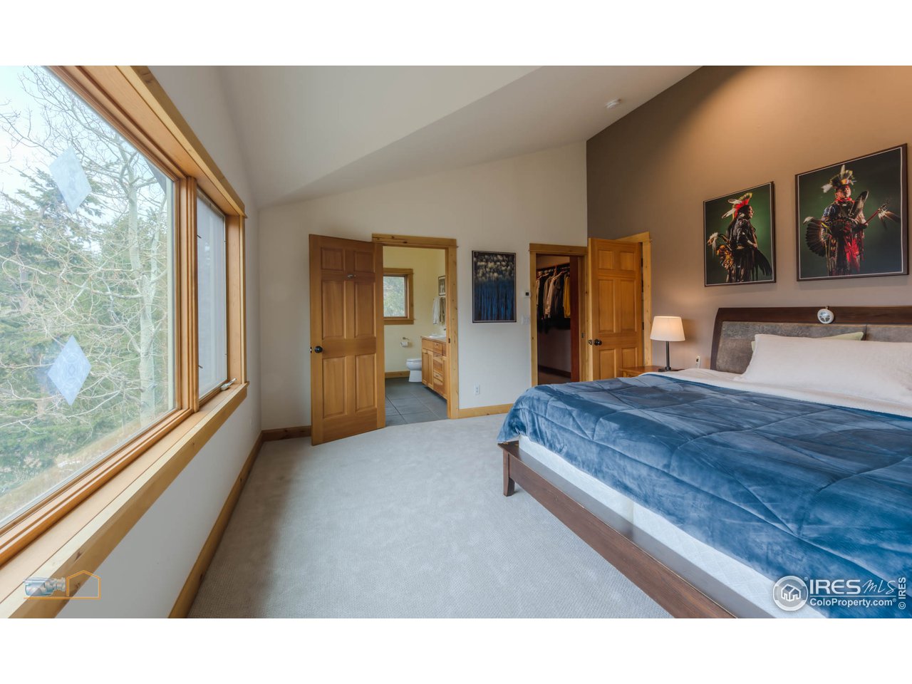 3301 Ridge Road Nederland, CO 80466 - Photo 25 of 40 a spacious bedroom with a bed and glass window