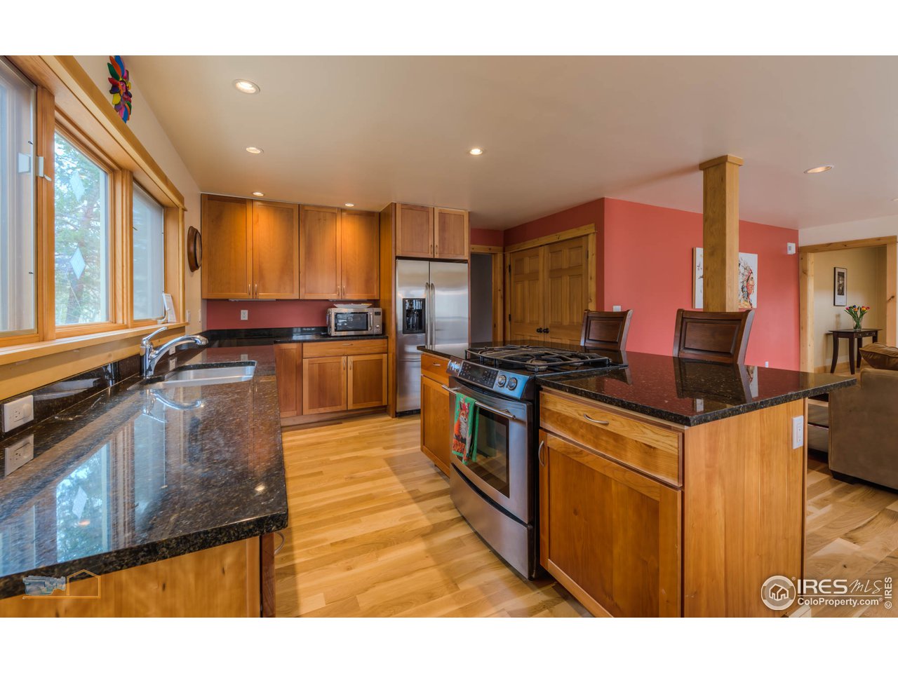 3301 Ridge Road Nederland, CO 80466 - Photo 9 of 40 a kitchen with stainless steel appliances granite countertop a stove a sink and a refrigerator